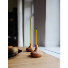 Lade das Bild in den Galerie-Viewer, Auf Holztisch stehend zwei Kerzenständer aus geöltem Eichenholz mit einer Ovo Slim Kerze und einer Ovo Dinner Kerze daneben schwarze Schale mit Kiwis
